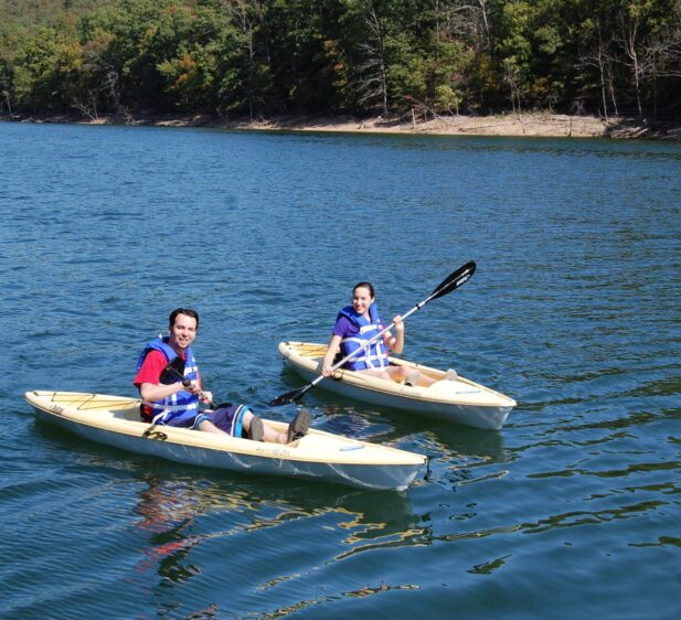 Two guests on solo kayaks on Beaver Lake provided complimentary to all registered guests.