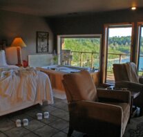 Robes, slippers, champagne and a bubbling Jacuzzi await overlooking Beaver Lake through the large picture window built flush with the rim of the spa tub.
