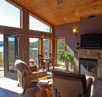 The view, fire place, and entertainment center as seen from the interior of one of our cabins on a sunny day.