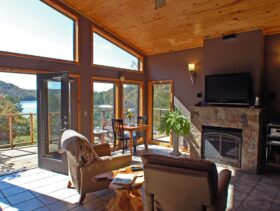 The view, fire place, and entertainment center as seen from the interior of one of our cabins on a sunny day.